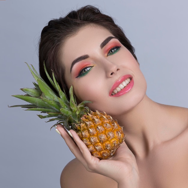 Woman holding pineapple