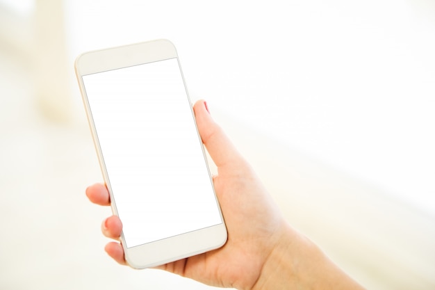 Woman holding a pink gold blank smartphone