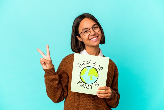 woman holding a planet save placard joyful and carefree