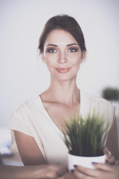 A woman holding a plant in her hands