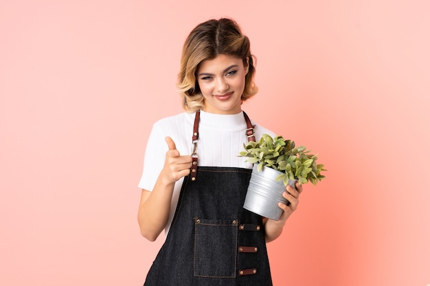 Woman holding a plant in studio