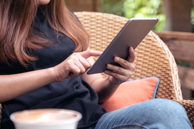 A woman holding and pointing at tablet pc