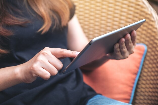 A woman holding and pointing at tablet pc