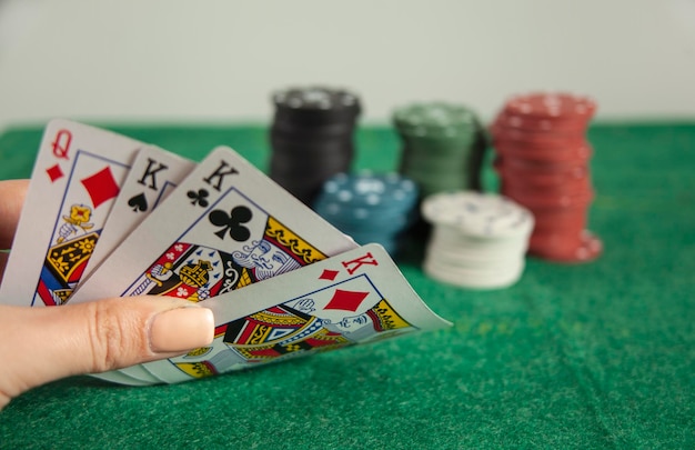 Woman holding poker aces with chips