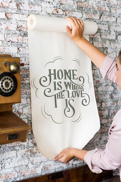 A woman holding a poster with motivation quote