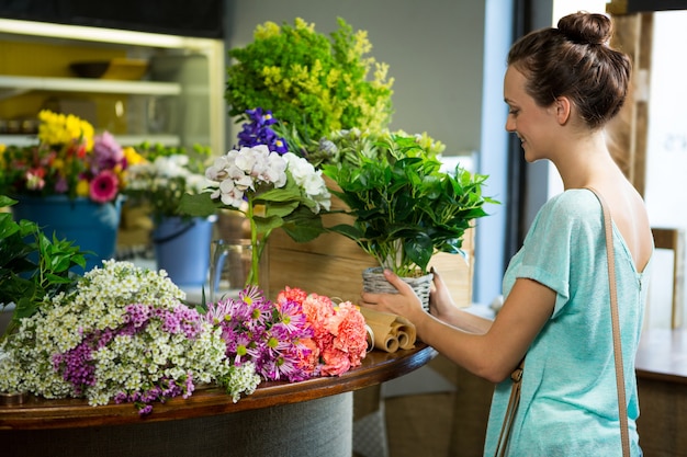 Woman holding pot plant