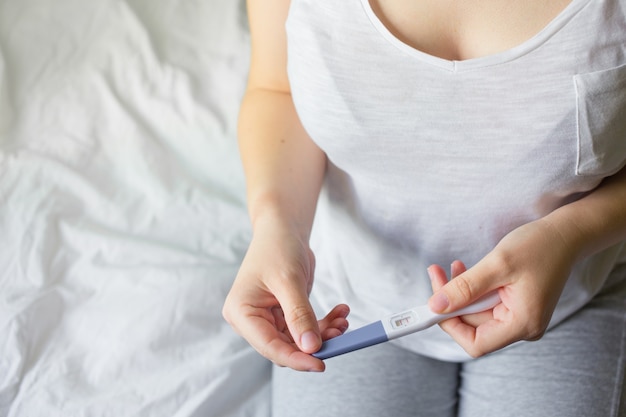 Woman holding pregnancy test, New life and new family concept.