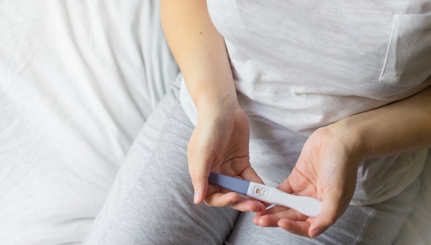 Woman holding pregnancy test, New life and new family concept.