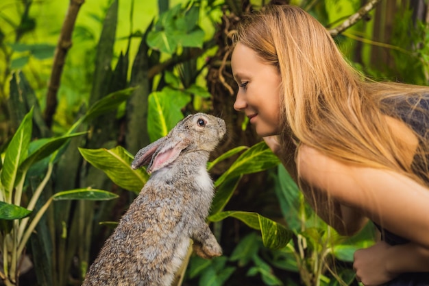 Woman holding a rabbit Cosmetics test on rabbit animal Cruelty free and stop animal abuse concept