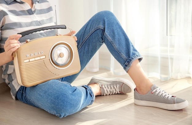 Woman holding radio at home