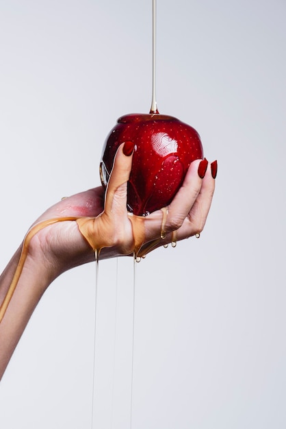 A woman holding a red apple and water running through  healthy concept