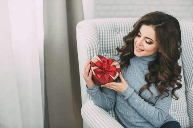 Woman holding a red gift box