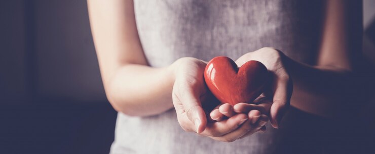 woman holding red he, health insurance