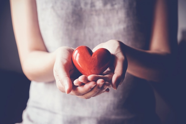 Woman holding red heart, health insurance, donation charity concept