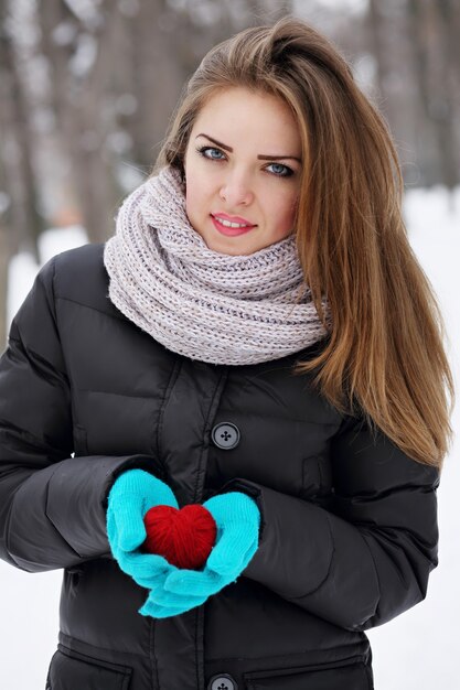 Woman holding a red heart.