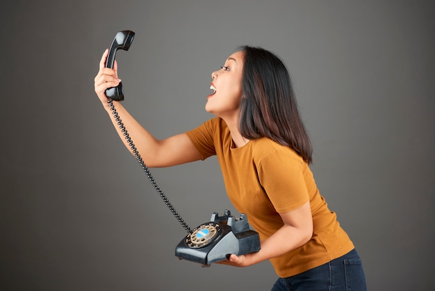 Woman holding retro phone
