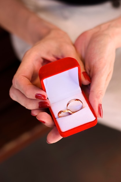 A woman holding rings for the newlyweds