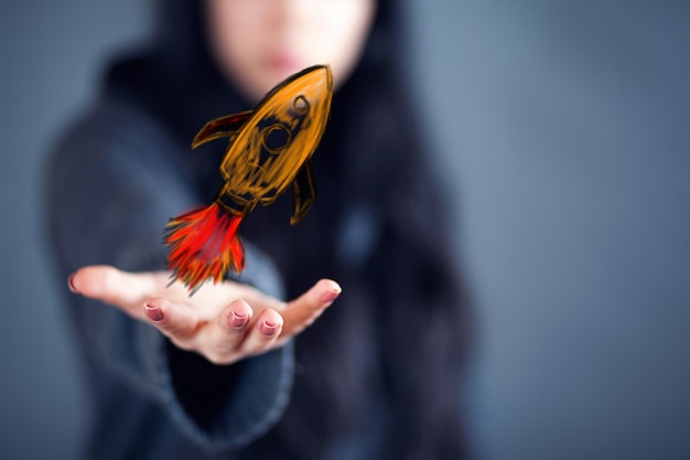 Woman holding rocket icon