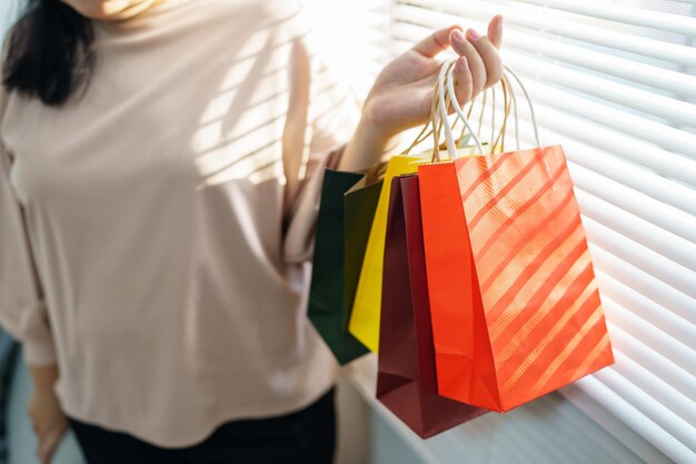 Woman holding sale shopping bags consumerism shopperxA lifestyle concept in the shopping mall shopping center with shopping bag