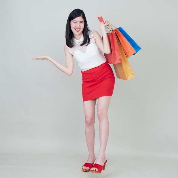 Woman holding shopping bag and credit cards