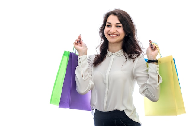 Woman holding shopping bags isolated on white wall