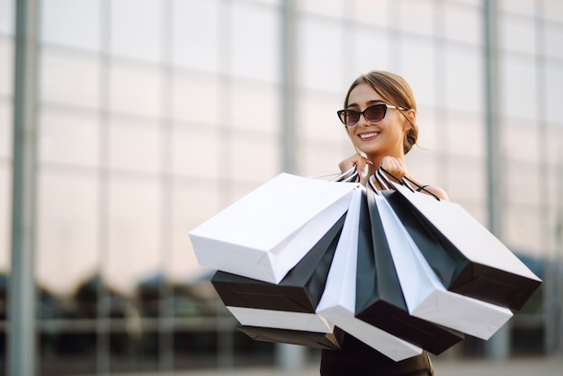 Woman holding shopping bags in the street