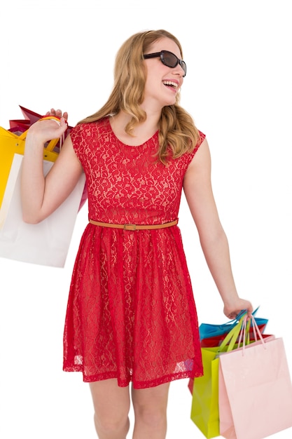 Woman holding shopping bags wearing sunglasses 