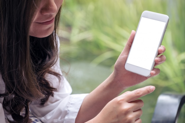 Woman holding and showing white mobile phone