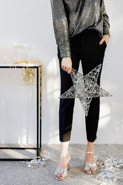 Woman holding a silver wire Christmas star