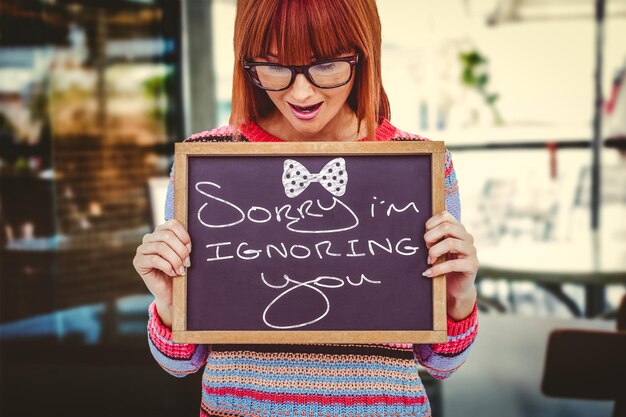 Woman holding small blackboard