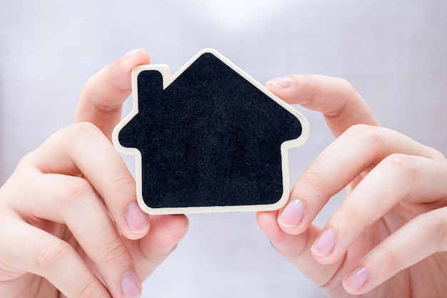 Photo woman holding the small home.  concept for real estate business.