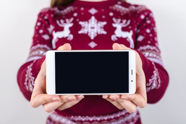 Woman holding smartphone in hand