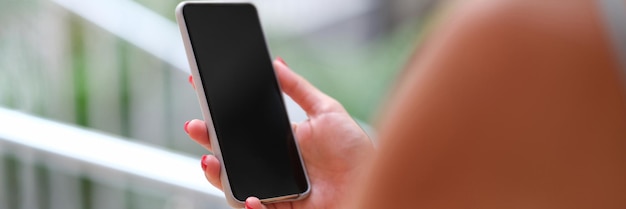 Woman holding a smartphone hands closeup