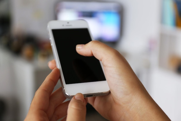 Woman holding smartphone indoors