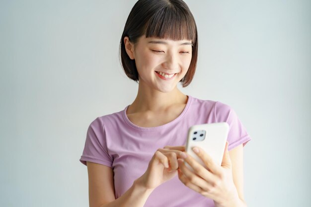 A woman holding a smartphone in sportswear