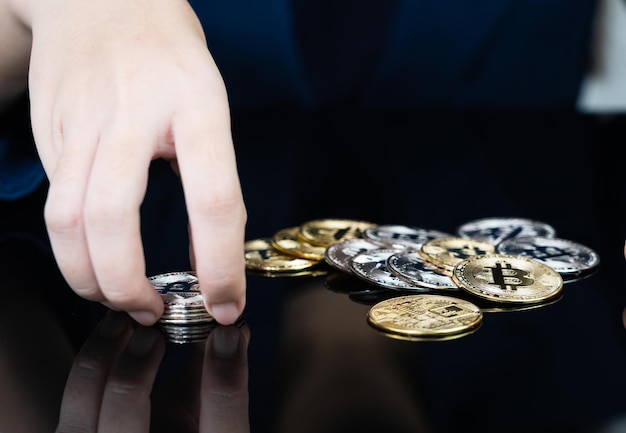 Photo woman holding some pieces of golden bitcoin token