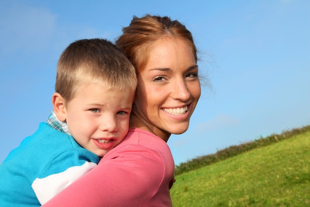 Woman holding son on her back