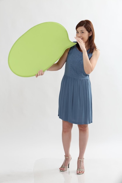 Woman holding speech bubble