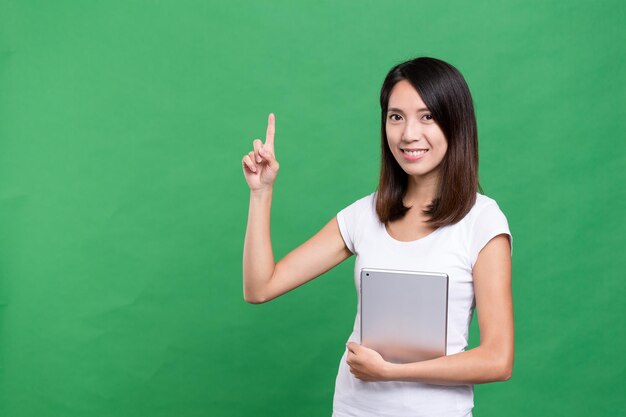 Woman holding tablet computer and finger point up