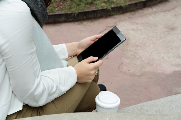 Woman holding tablet computer with blank screen