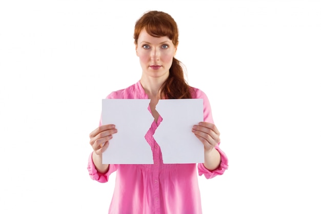 Woman holding torn sheet of paper