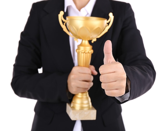 Woman holding trophy cup on white