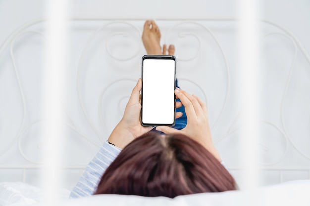 Photo woman holding and using phone with blank white screen