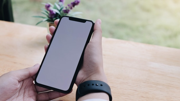 Woman holding and using a smartphone