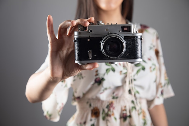 woman holding a vintage camera