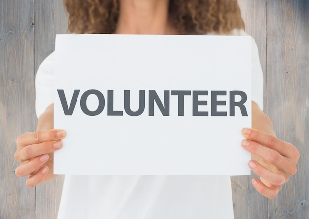 Photo woman holding a volunteer placard