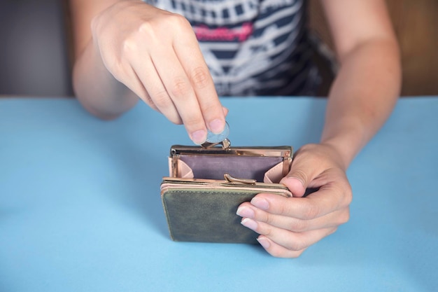 Woman holding wallet and coins