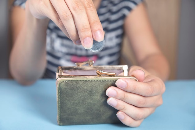 Woman holding wallet and coins