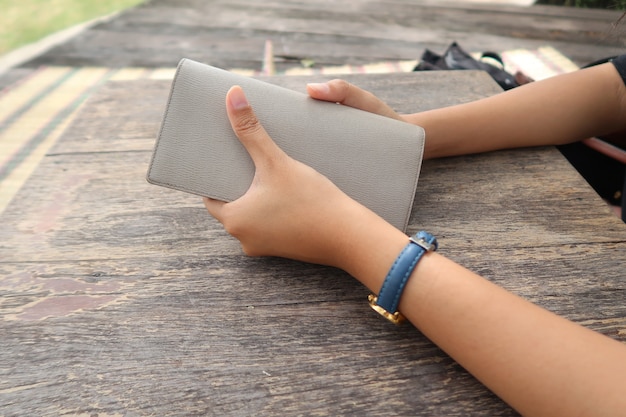 Woman holding wallet in her hands.