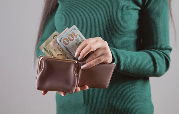 Woman holding wallet with money